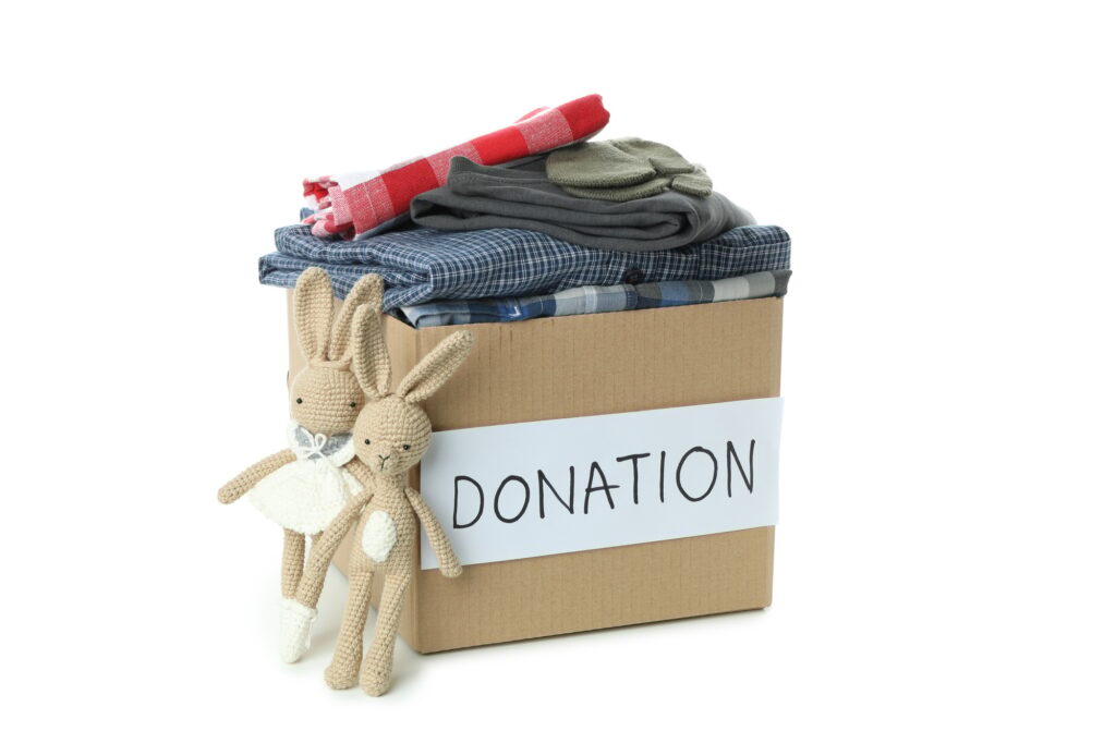 Donation box with clothes isolated on white background